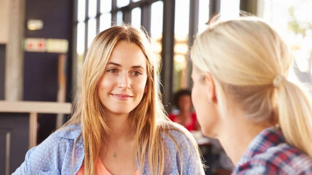 Primer plano de dos mujeres hablando en un café
