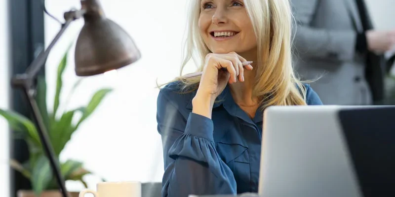 mujer sonriente y de buen humor en la oficina, descansada